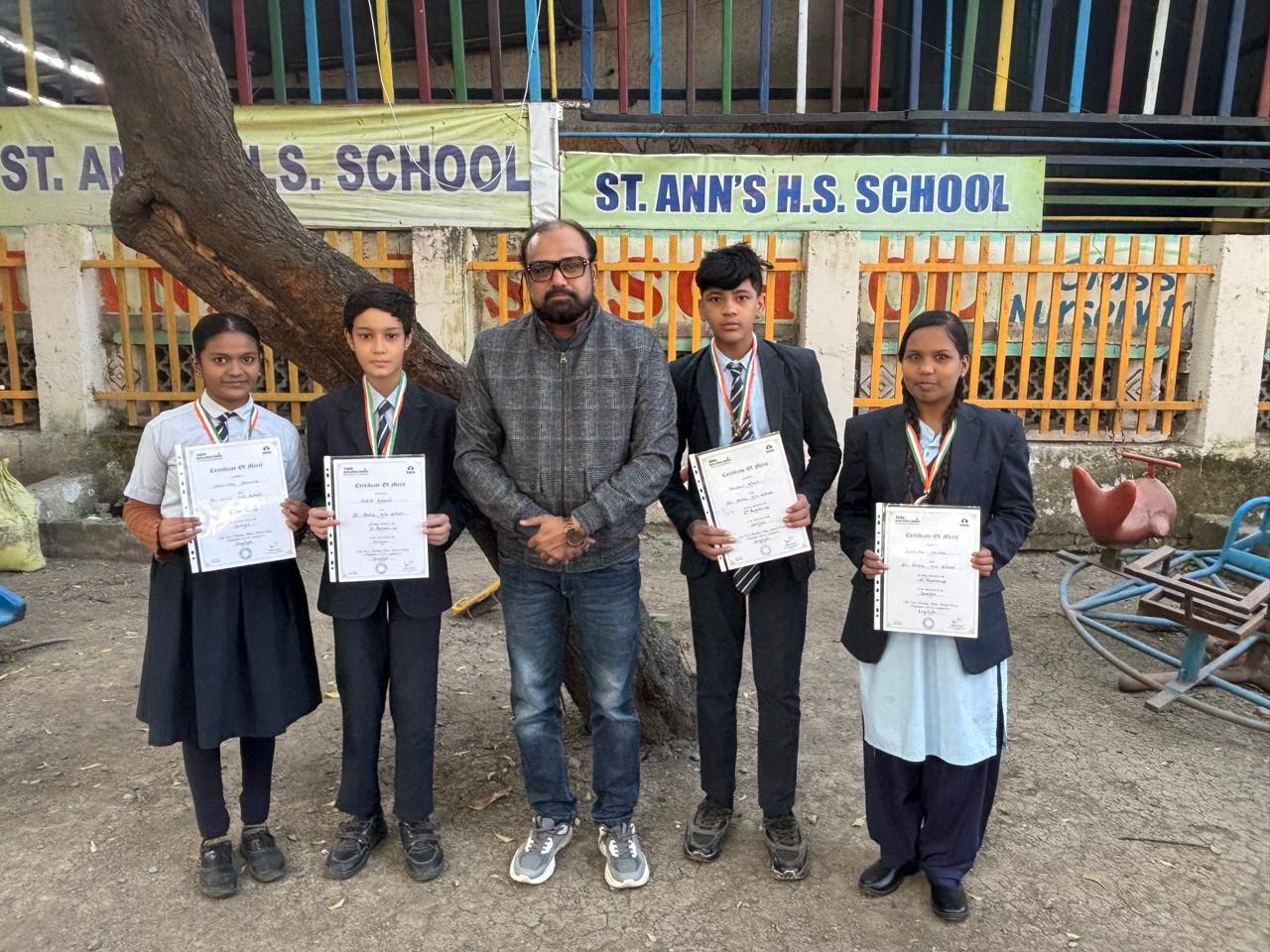 Students receiving recognition certificates at Saint Ann's School