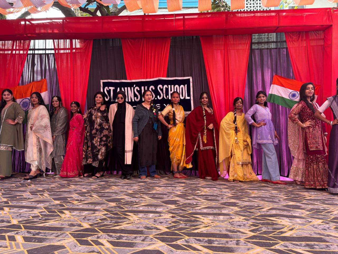 Students and faculty standing together on stage at Saint Ann's School