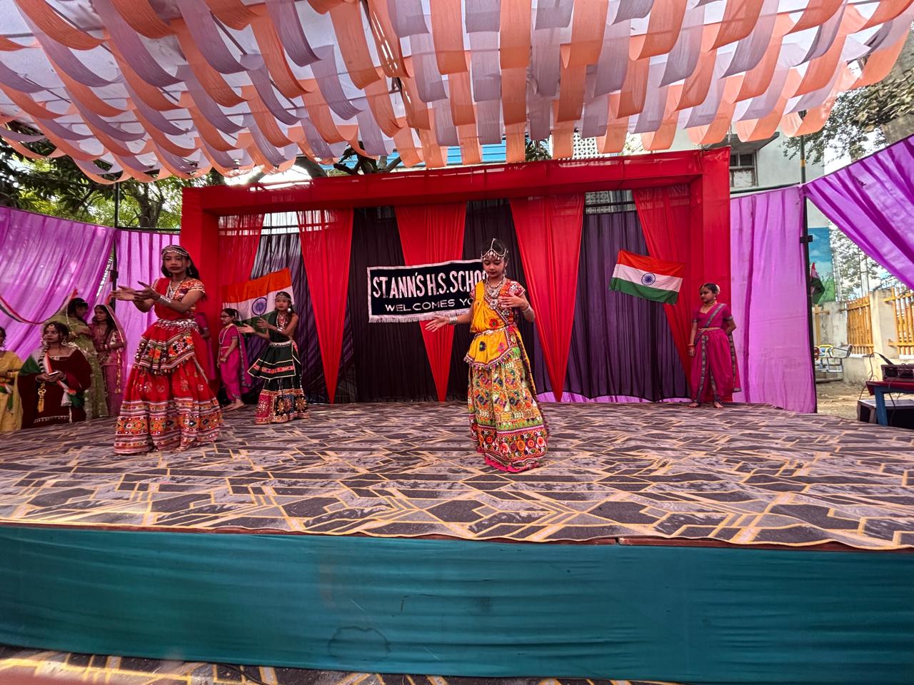 Students performing on stage during a cultural event at Saint Ann's School