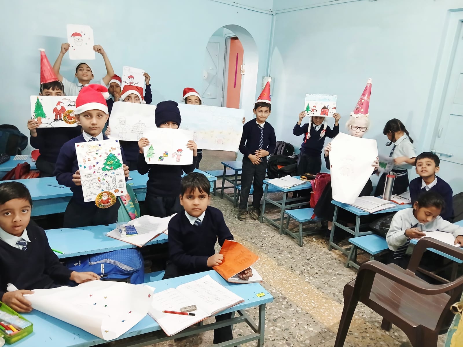 Primary students displaying classroom artwork at Saint Ann's School